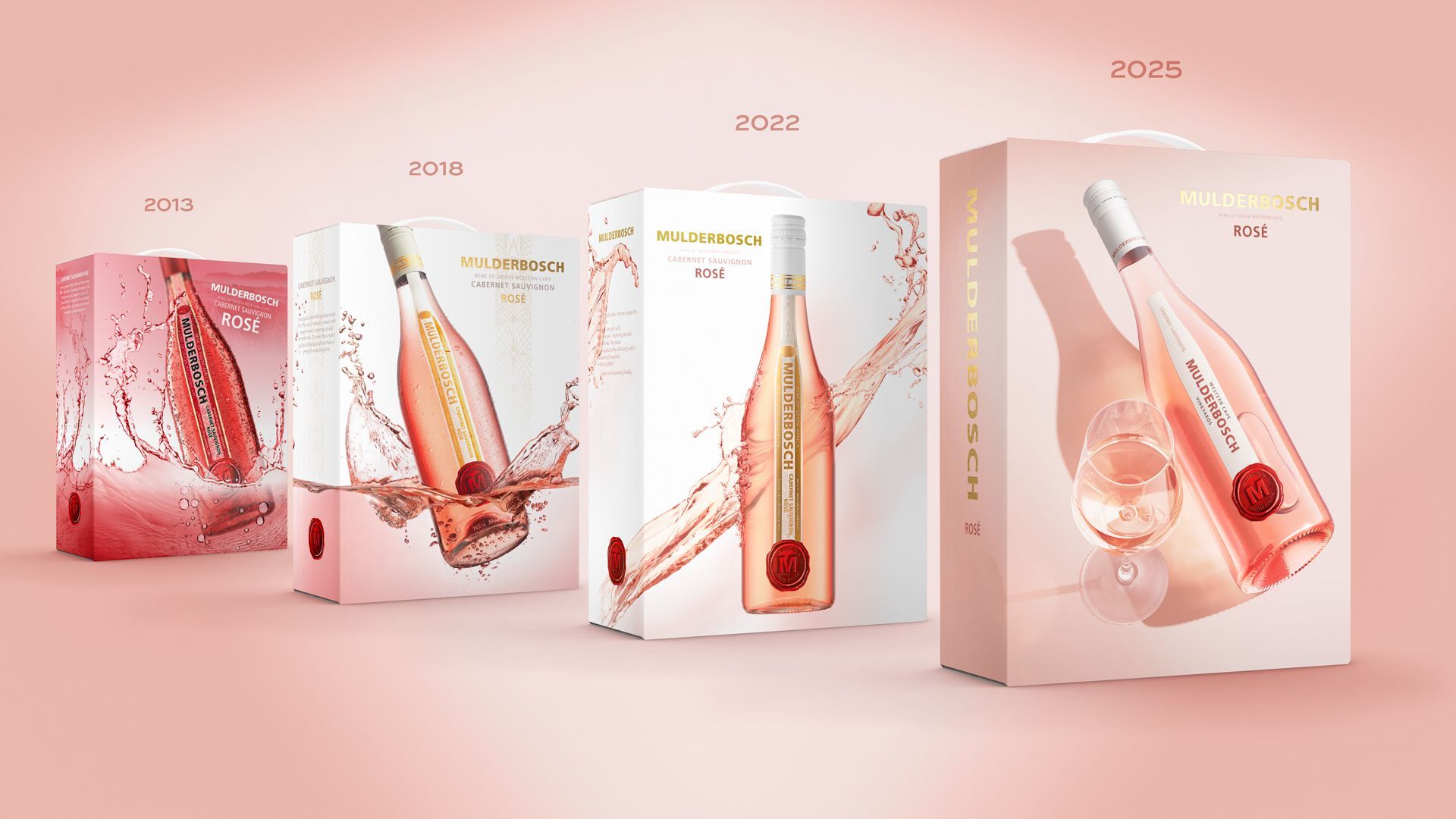 Four wine boxes in a row, each with a champagne bottle design, in shades of pink, with splash graphics.