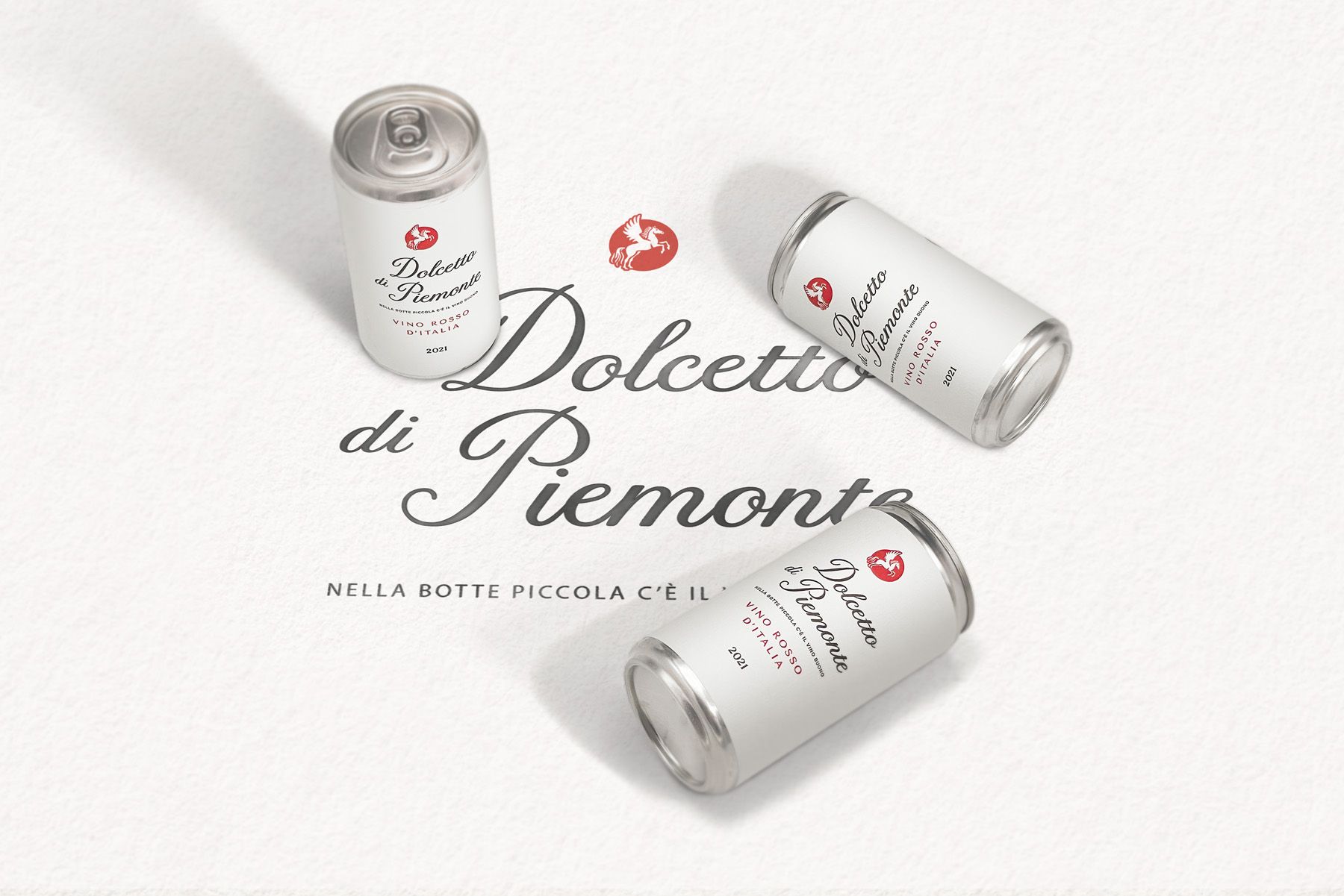 Three cans with wine from Piemont on a white surface.