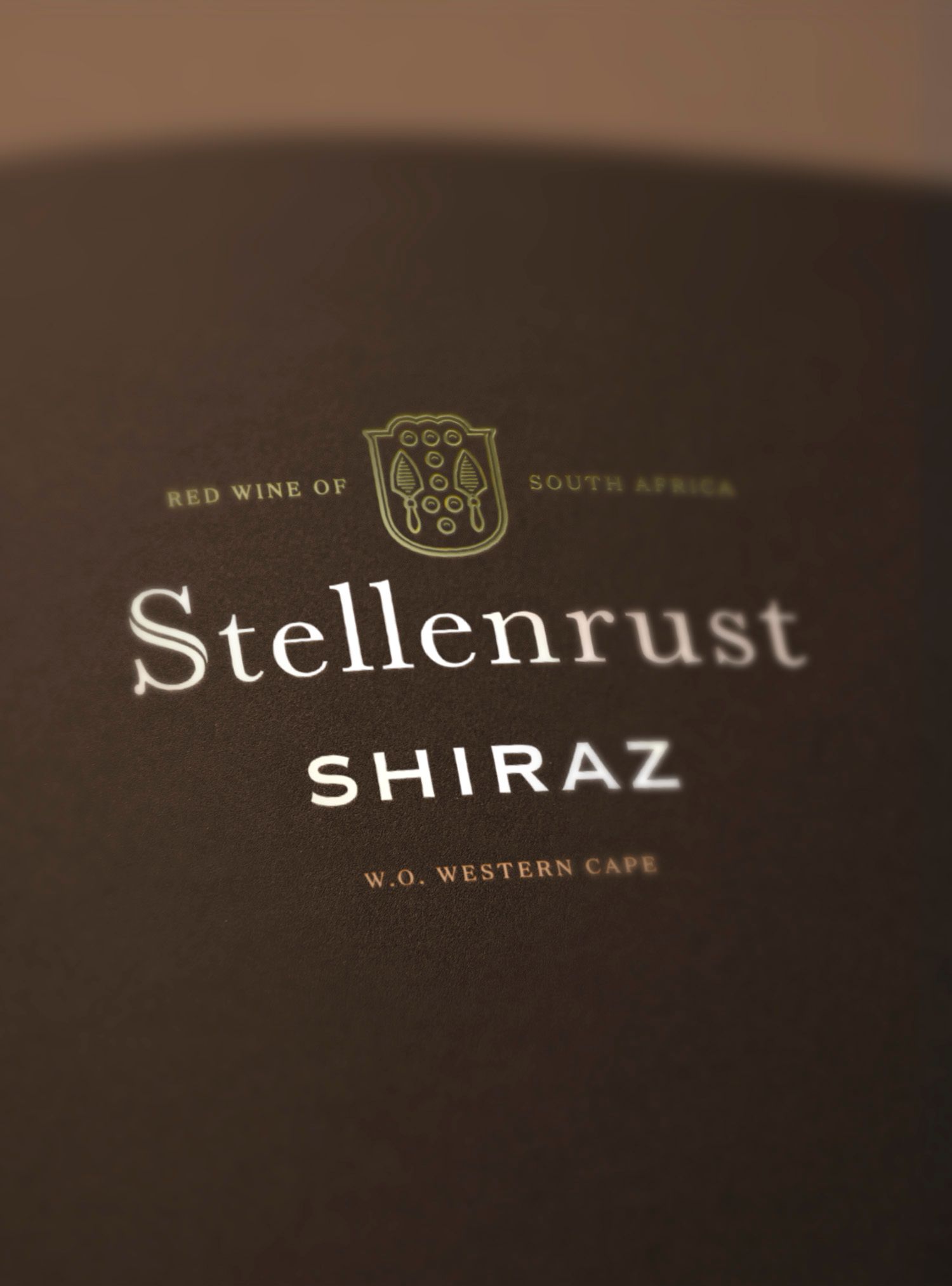 Stellenrust Shiraz wine label, brown with gold lettering and a crest;