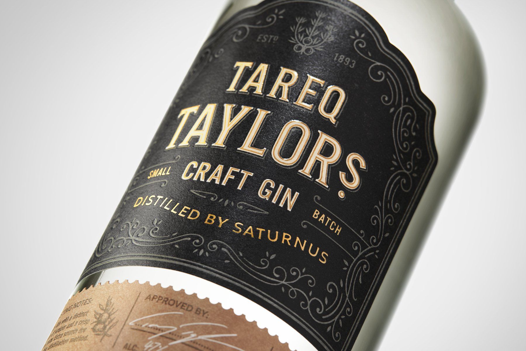 Close-up of a gin bottle with a black and gold label that reads 