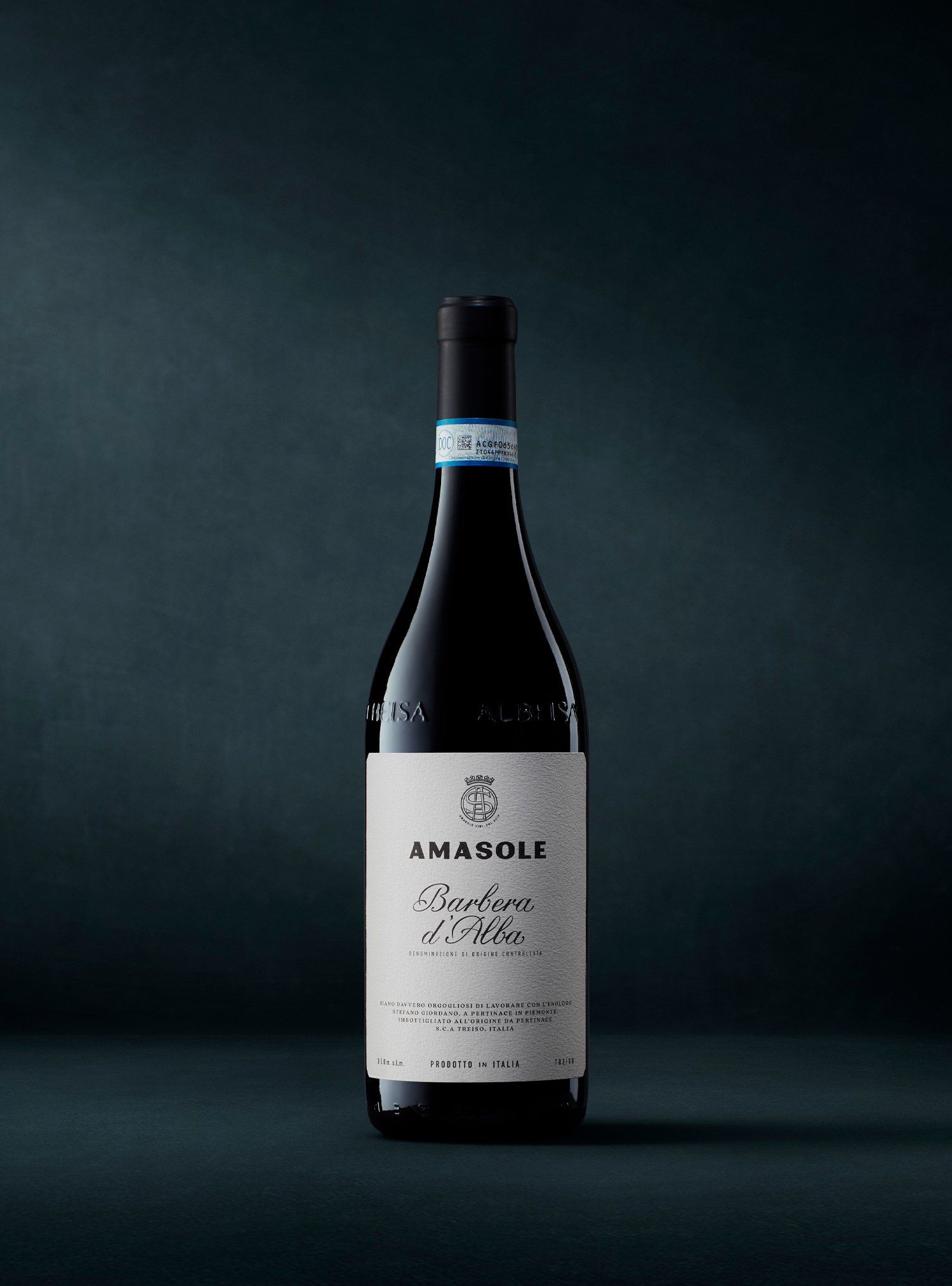 Wine bottle against a dark teal background. Label reads