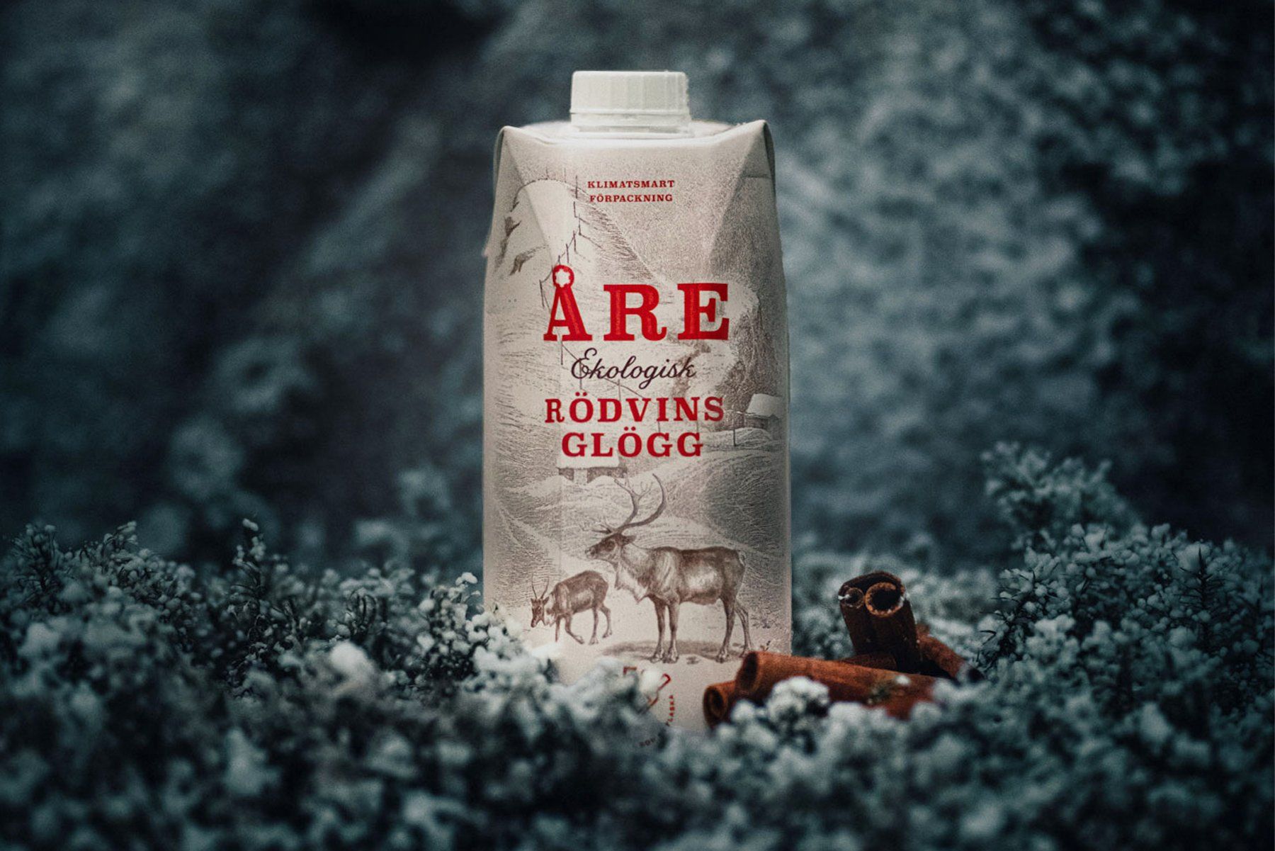 Carton of Åre organic red wine glögg, with reindeer illustration, set in snow.