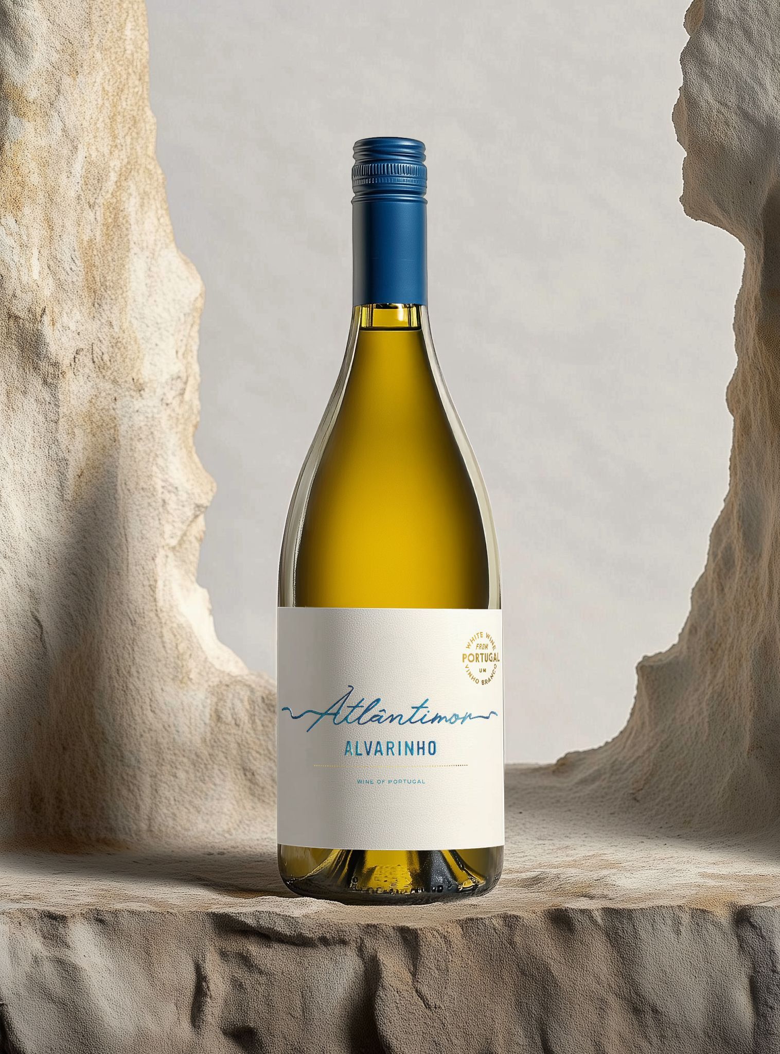 White wine bottle with a blue cap and white label, set against a light brown, abstract stone background.