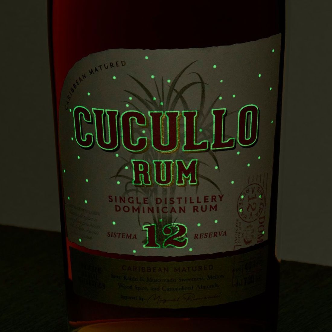 Bottle of Cucullo Rum with glowing green accents on label.
