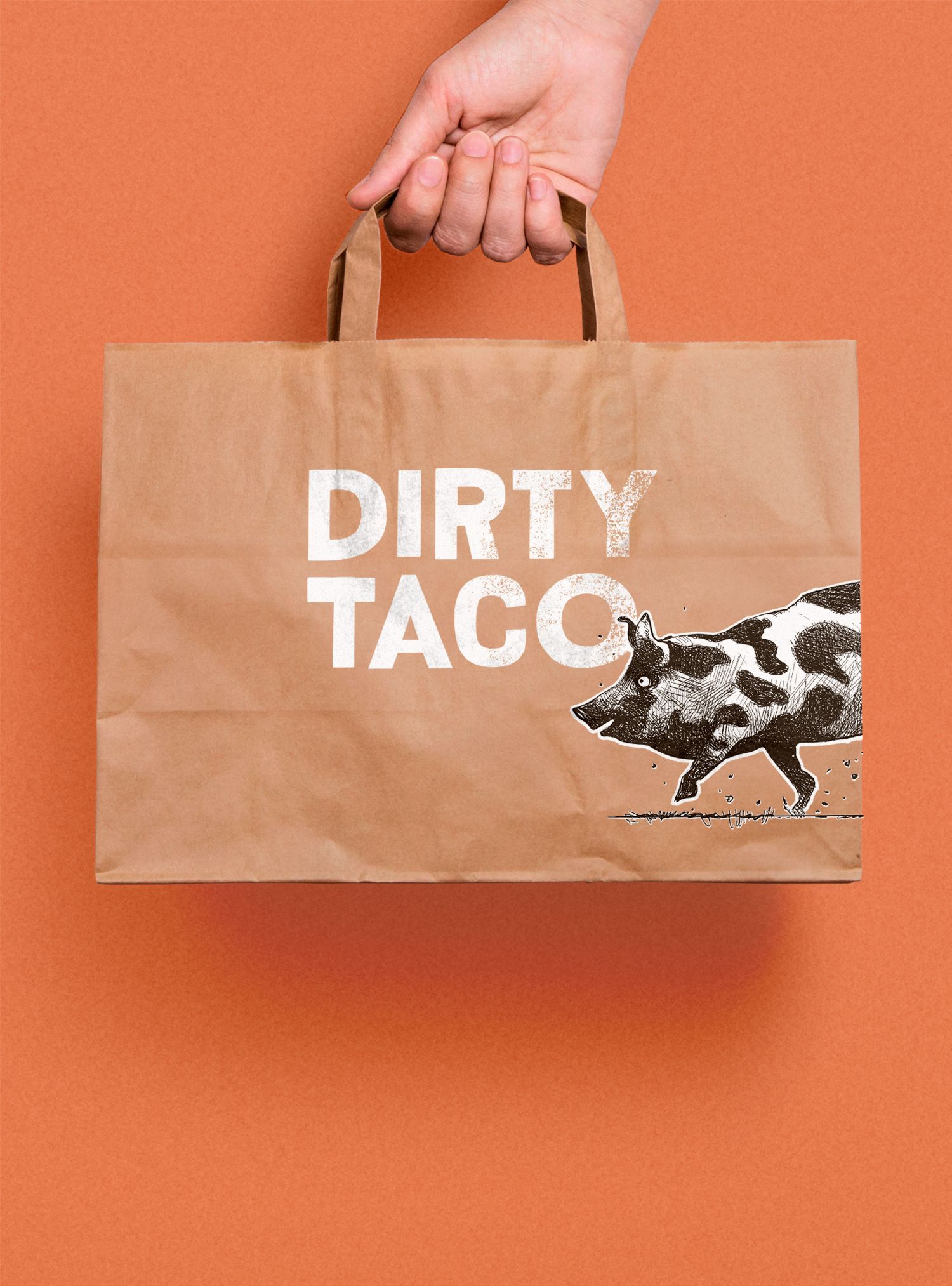 Hand holding a brown paper bag with