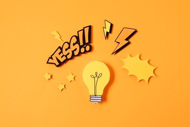Yellow light bulb with comic-style “YES!!” text and lightning bolts on an orange background