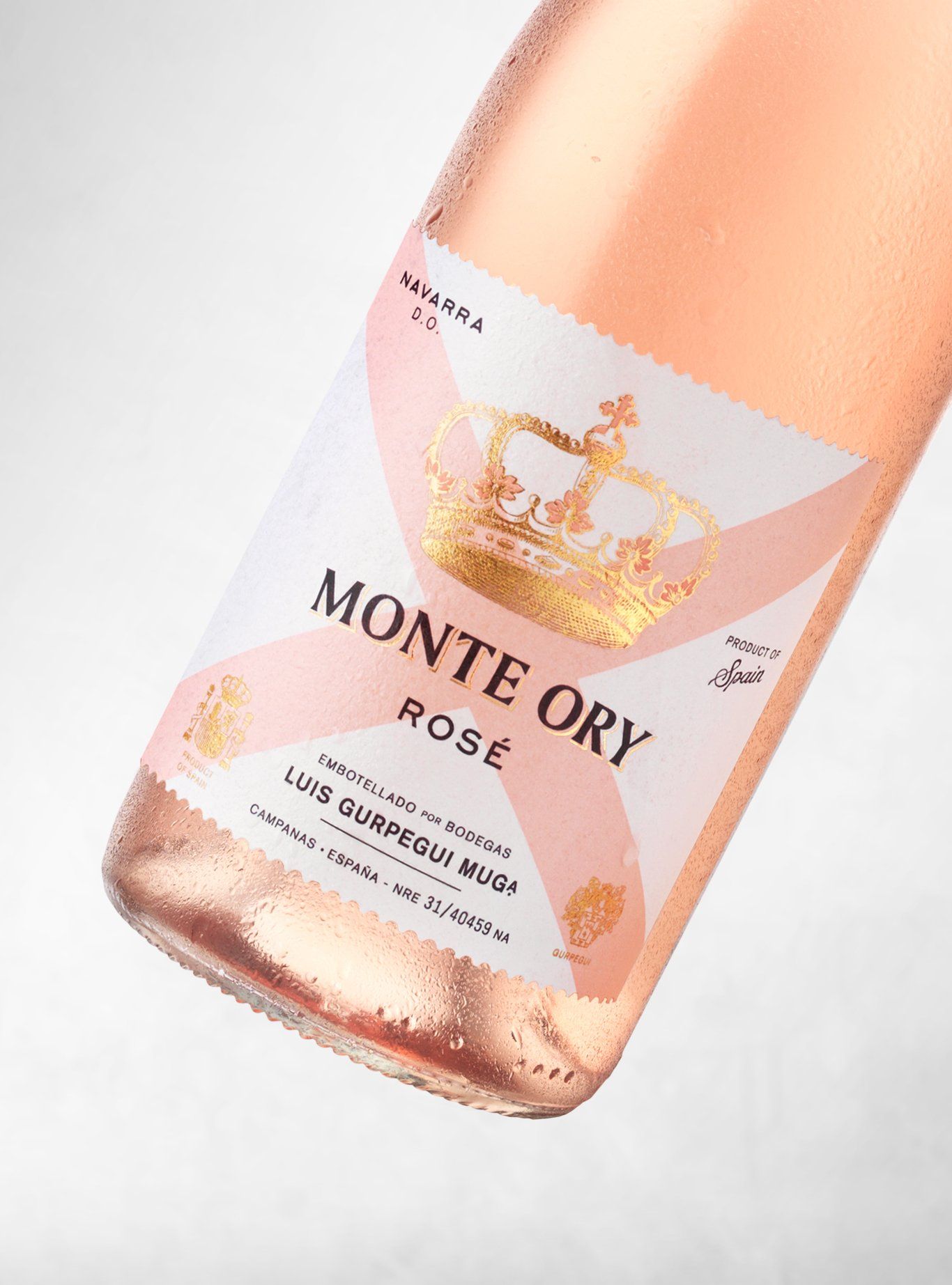 Rose wine bottle, pale pink with a label featuring a golden crown and the words 