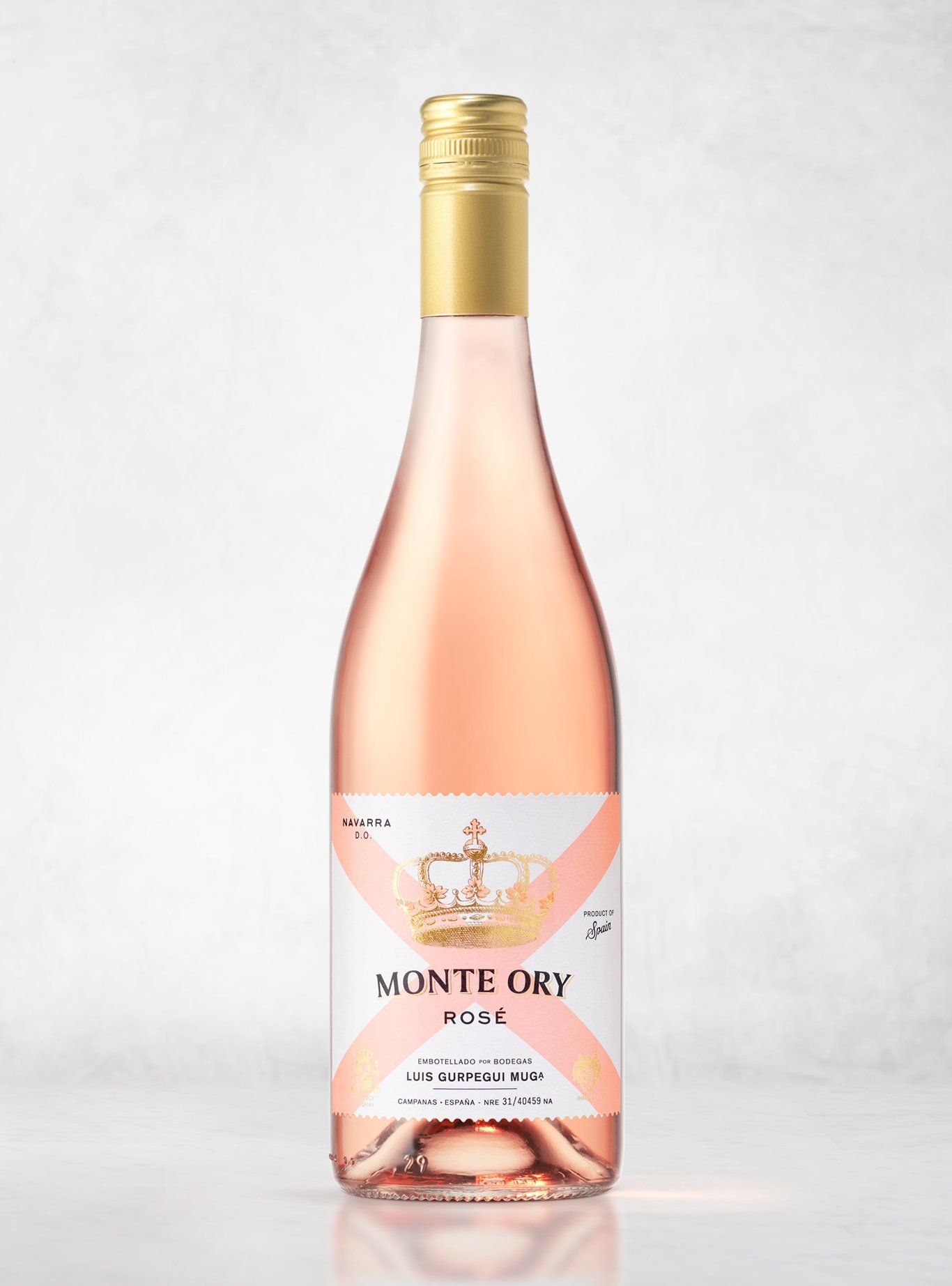 Bottle of Monte Ory Rosé wine, pale pink liquid, gold cap, label with crown.