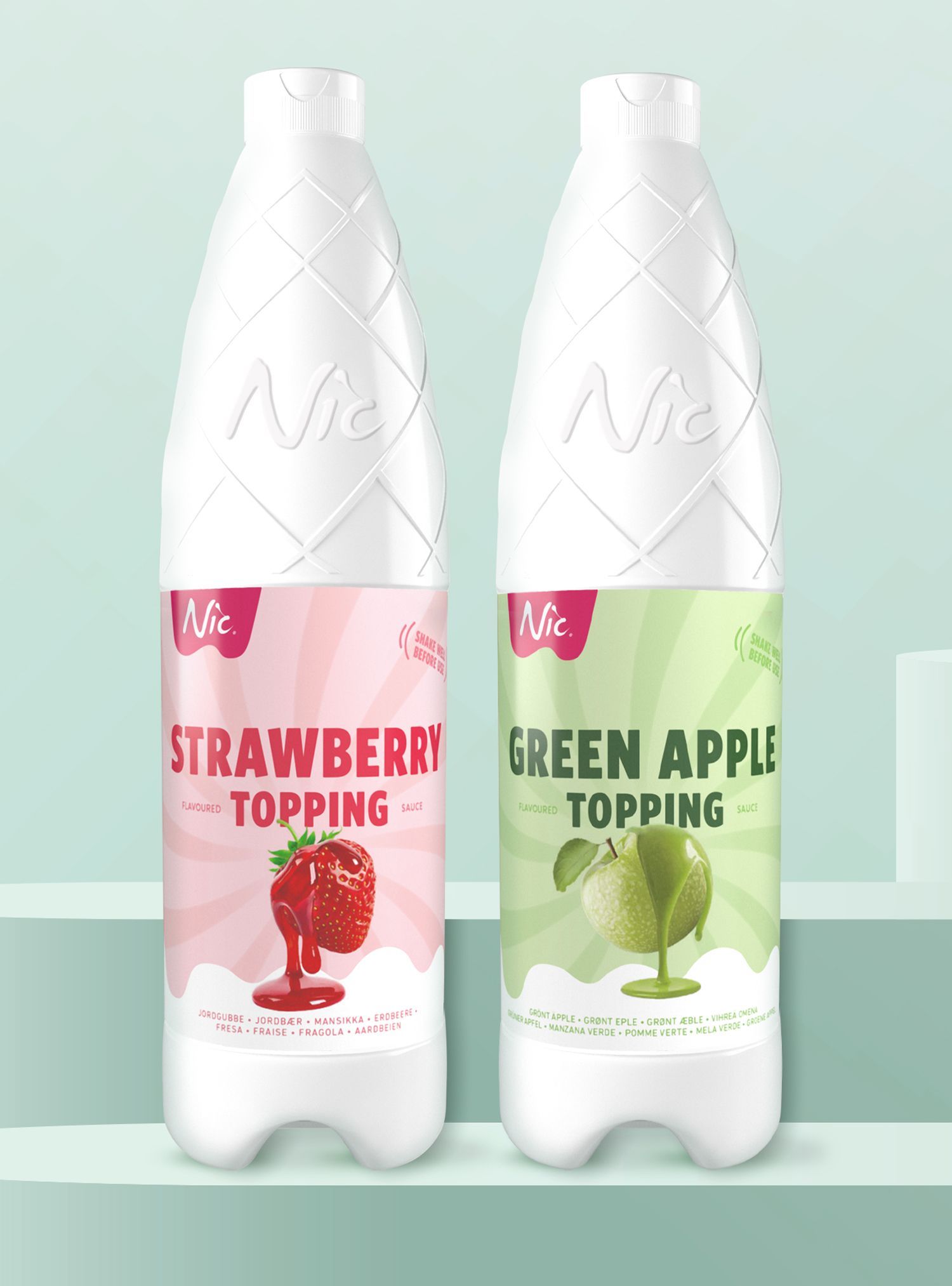 Two white bottles of Nic Strawberry and Green Apple Topping. Each bottle has a colored label with the flavor and a graphic.