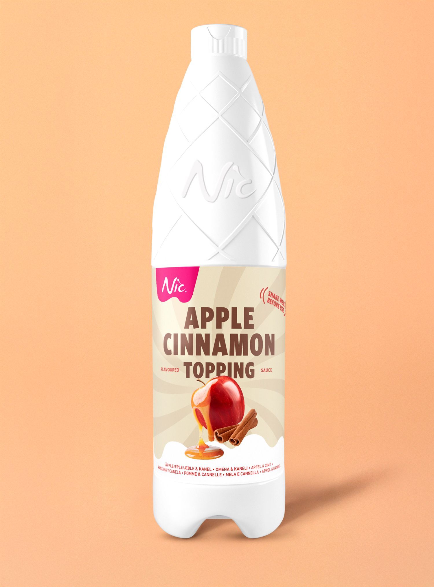 Bottle of apple cinnamon topping on peach background.