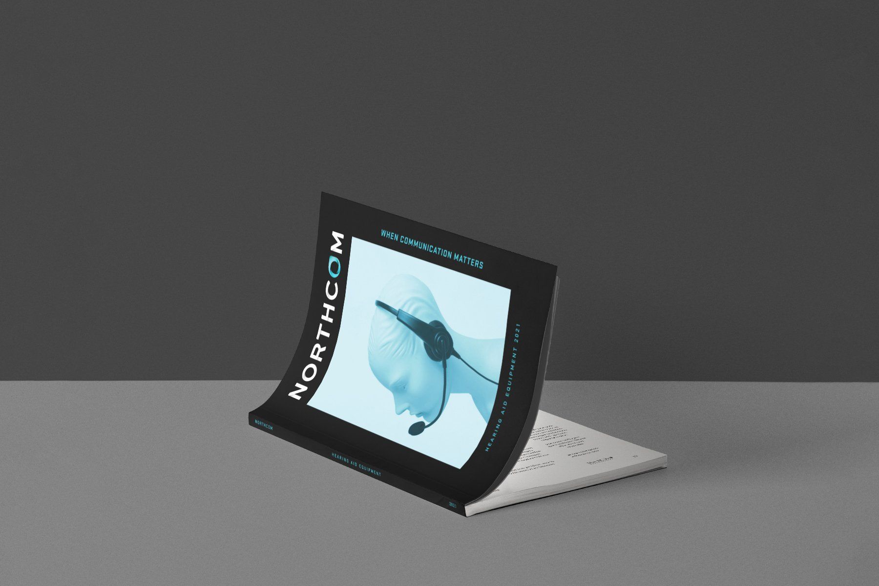 A curved display on a gray surface shows a person with a headset. The Northcom logo is visible.