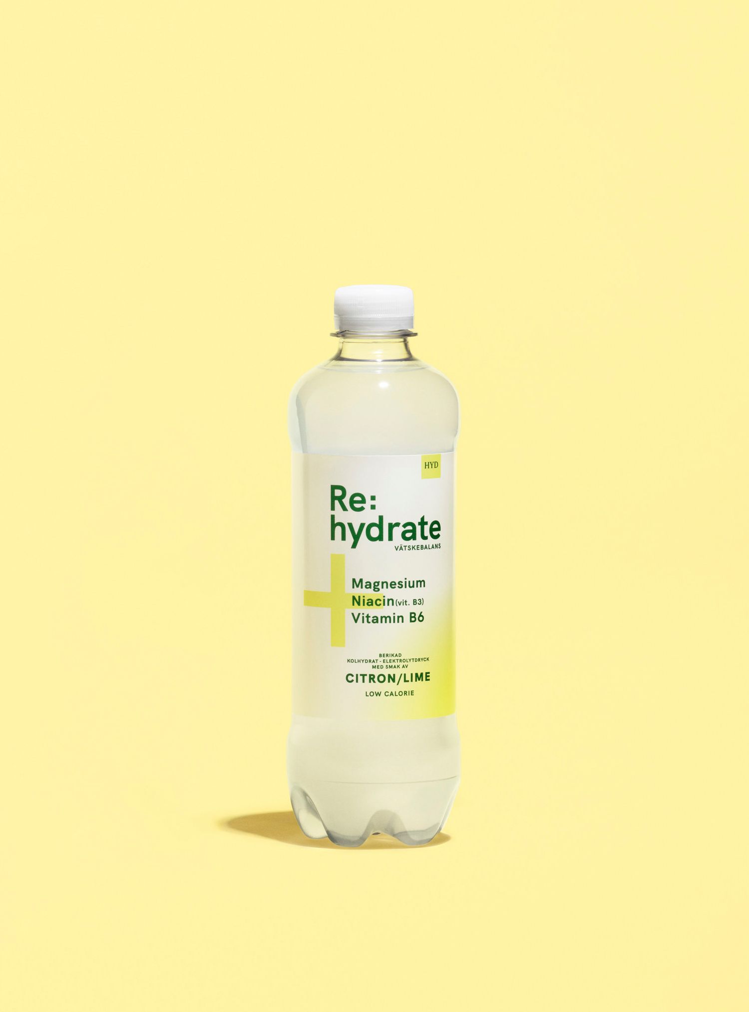 Clear bottle of Re:hydrate beverage on a yellow background.