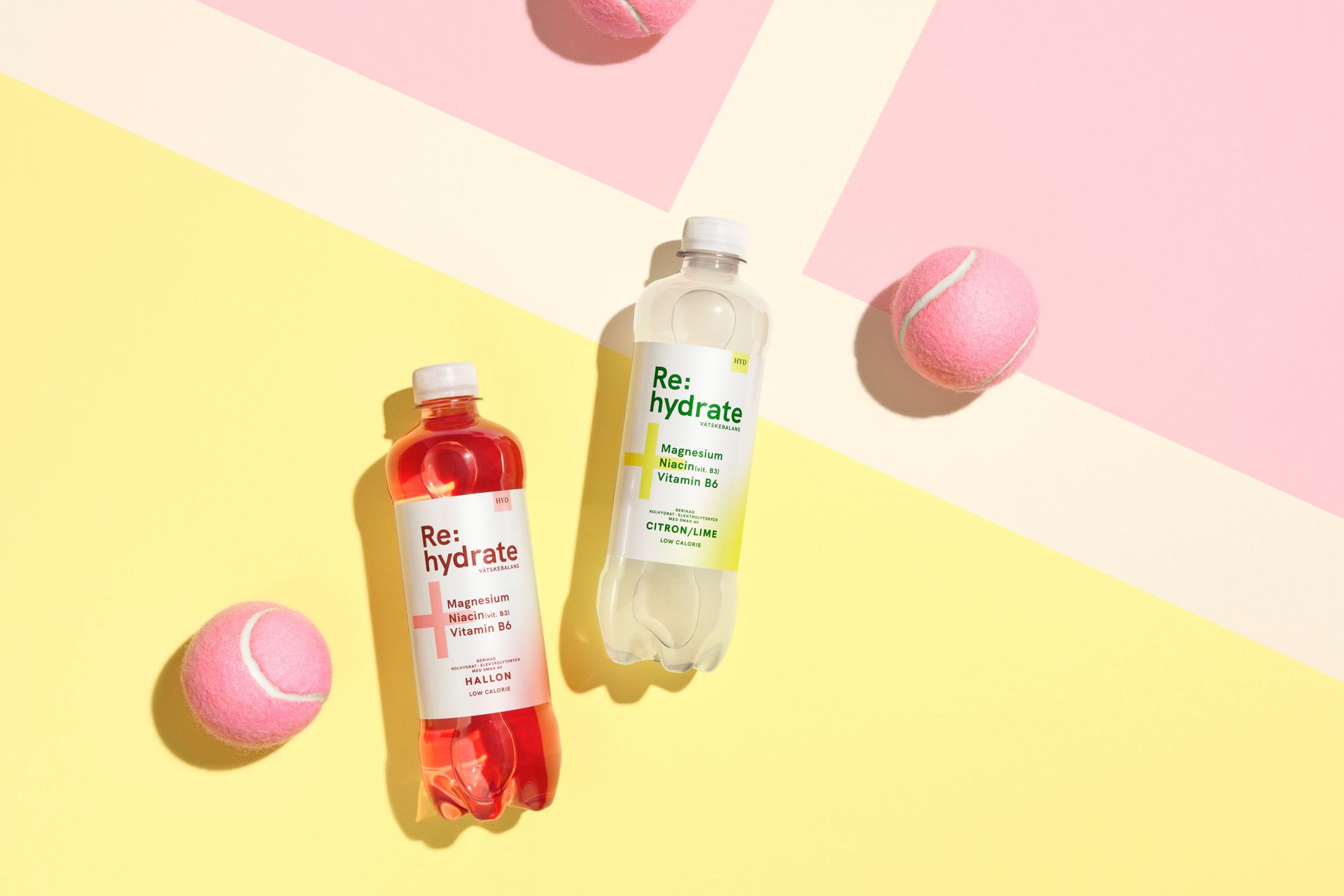 Two bottles of pink and clear beverages with tennis balls on yellow and pink background.