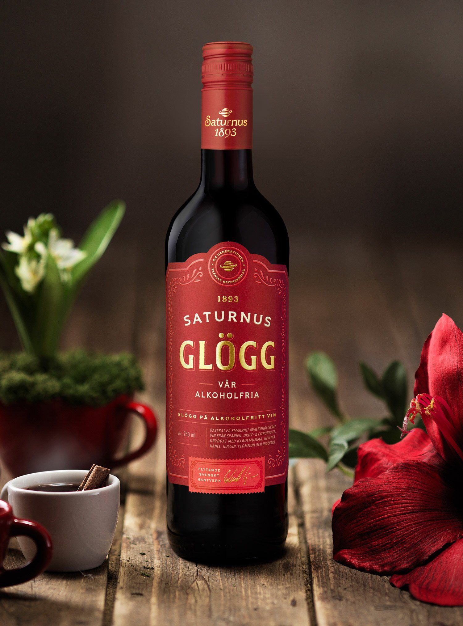 Bottle of Saturnus Glögg wine on a wooden surface, with red label and festive decorations.