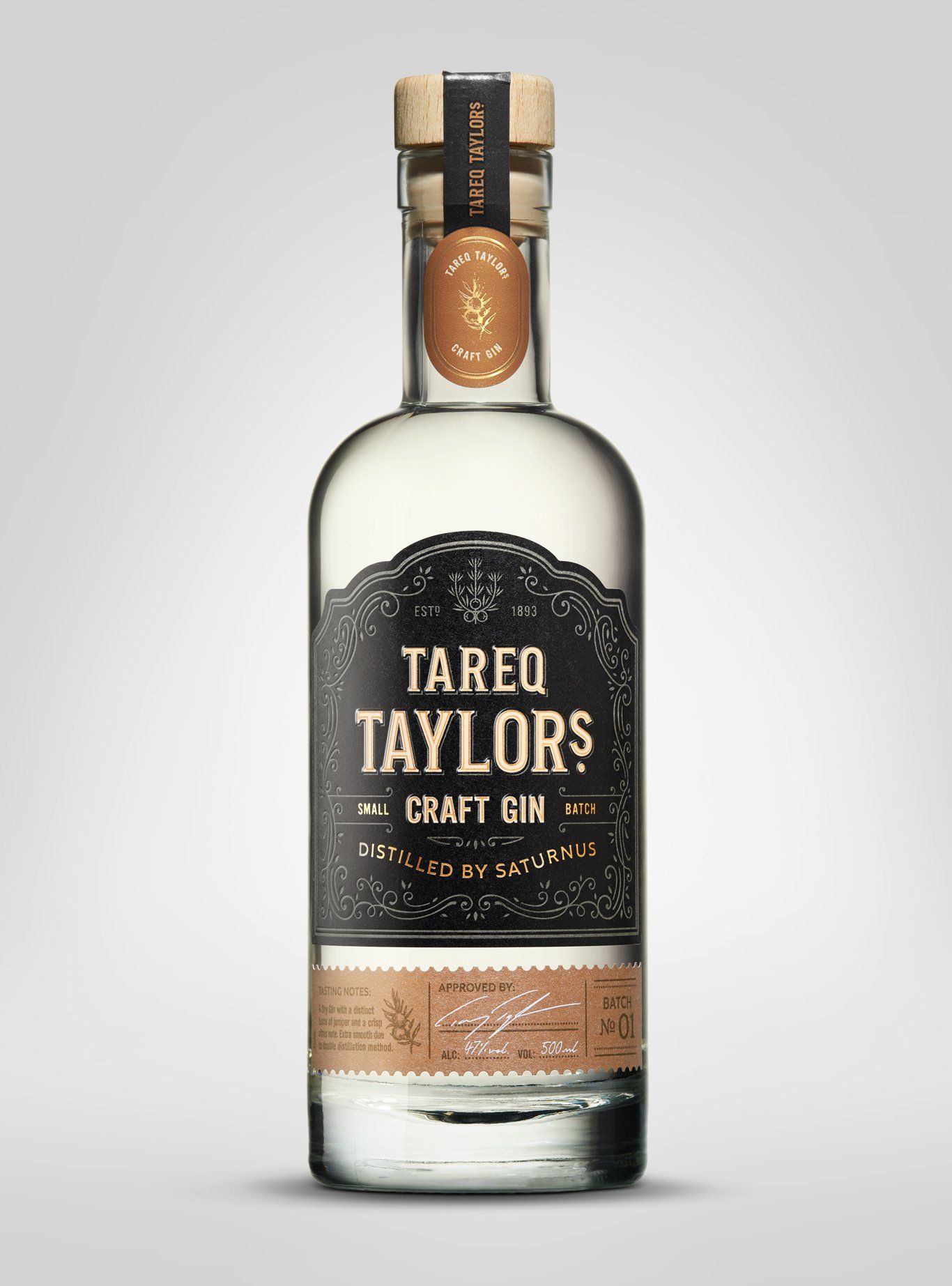 Bottle of Tareq Taylor's Craft Gin with black and tan label, cork stopper, and light background.