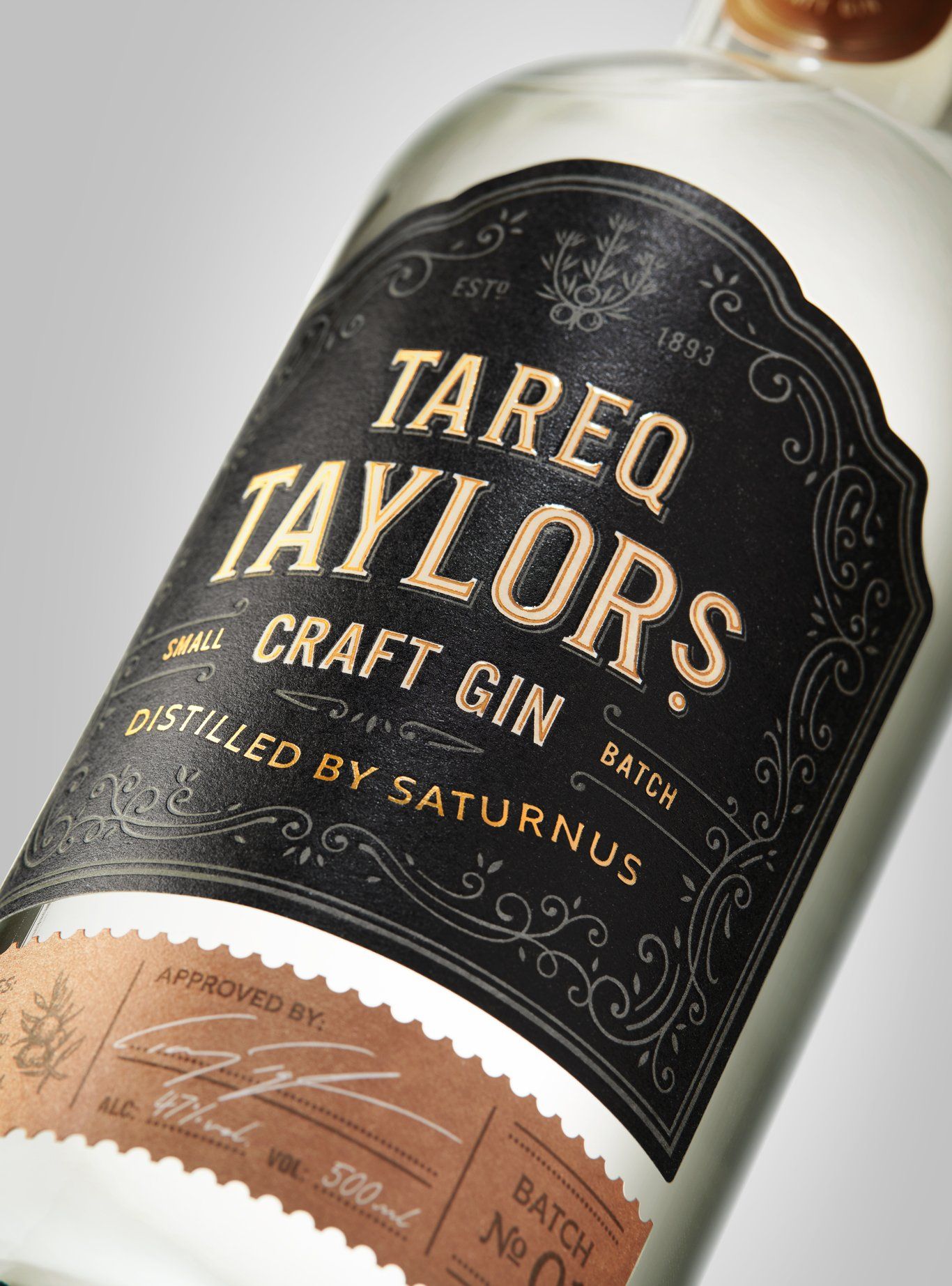 Tareq Taylors Craft Gin bottle, black and gold label, clear glass.