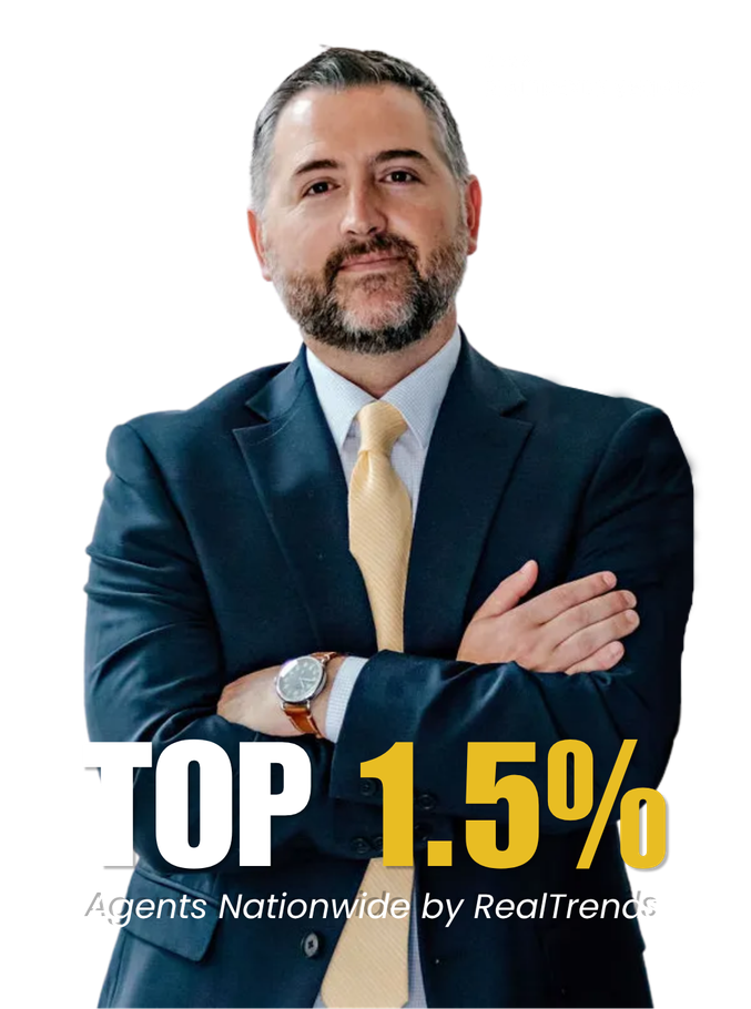 Man in navy suit with arms crossed; bold text reads “TOP 1.5%” and “Agents Nationwide by RealTrends”