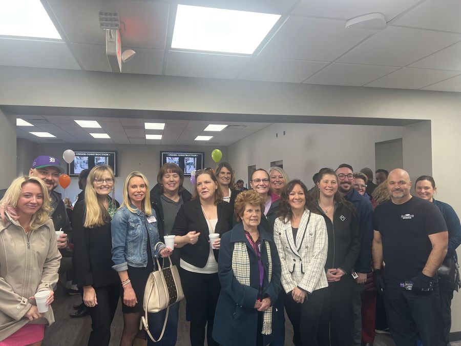 A group of people are posing for a picture in a room
