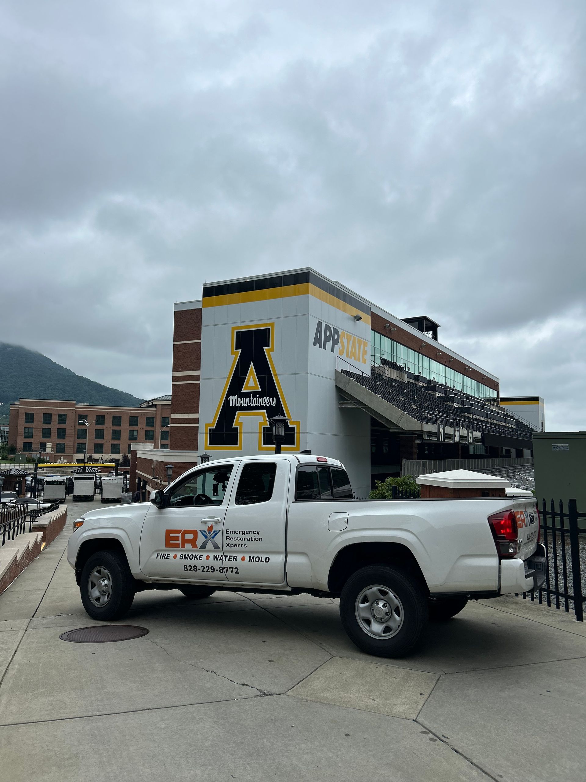 White pickup truck in front of an Appalachian State stadium entrance with a large black-and-gold “A” logo.