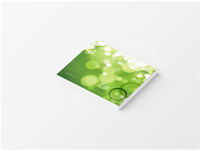 Book with green cover and bokeh effect, angled on a white surface.