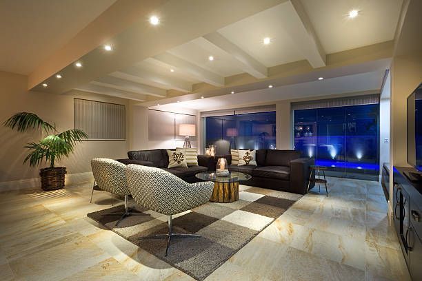 A living room with a couch , chairs , and a television.
