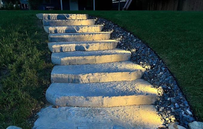 A set of concrete steps leading up to a house.