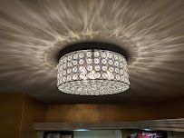 A chandelier is hanging from the ceiling in a room.