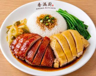 Roast chicken rice plate with greens and two glazed meat portions on a white dish