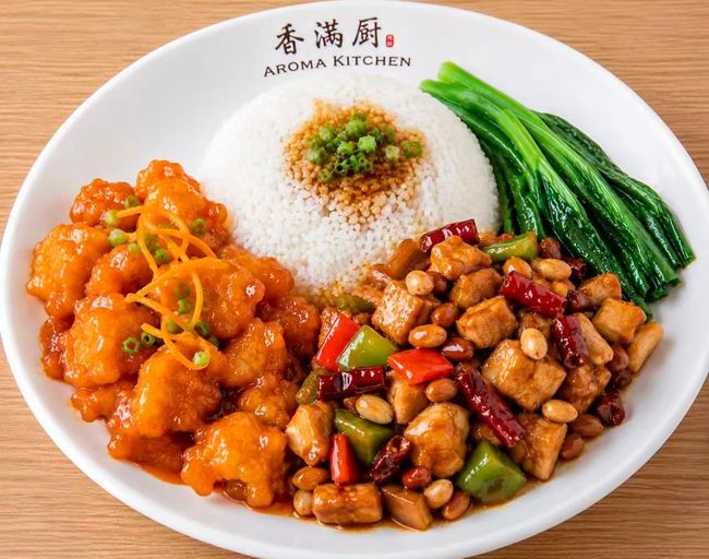 Chinese takeout plate with rice, orange chicken, tofu, and green vegetables on a white dish