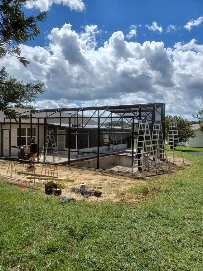 A house is being built in the middle of a grassy field.