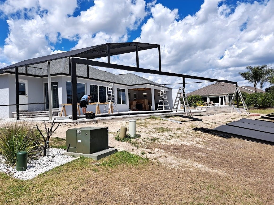 A house is being built with a metal structure in the backyard.