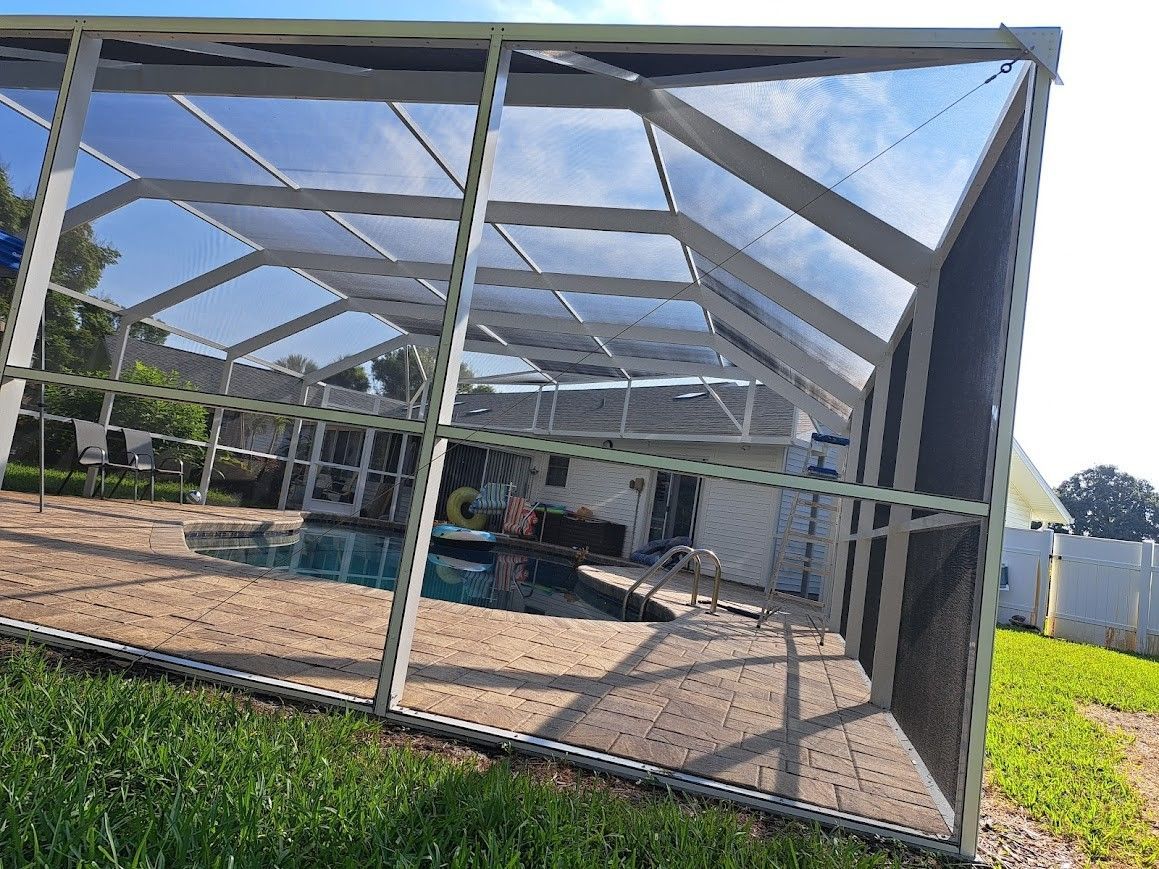 A screened in swimming pool with a broken screen.