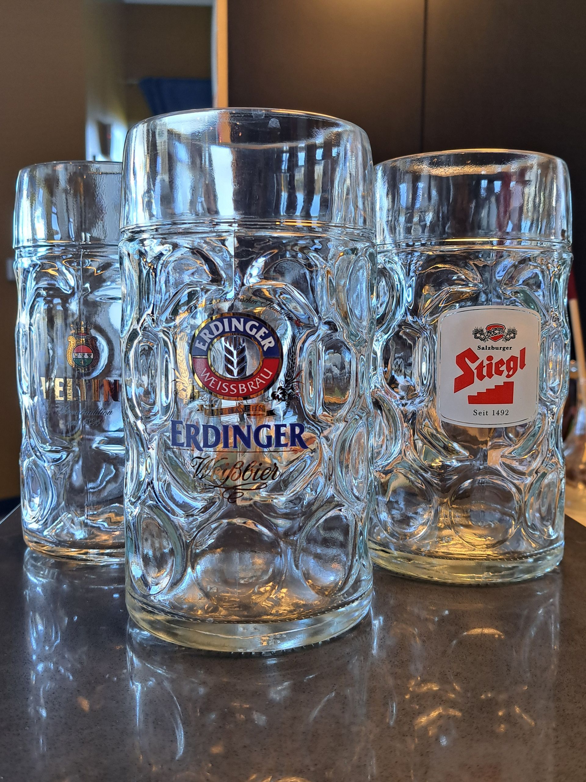 Four glass beer steins, three with 