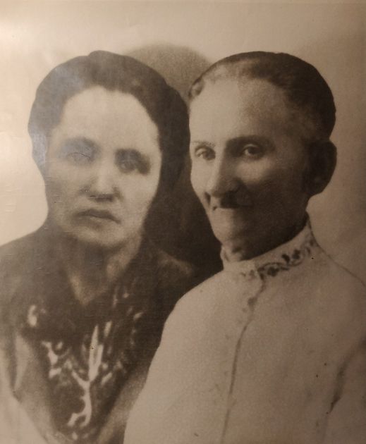 Two women, shoulder up, posed for a sepia-toned photograph. Woman on right has a detailed collar.