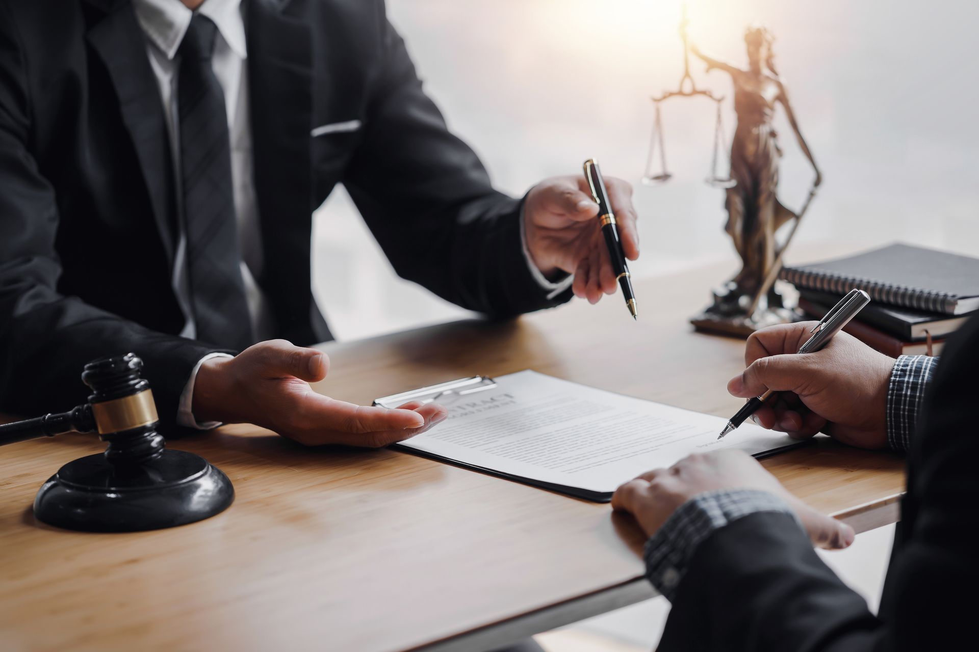 a man at a desk with a gavel and scales of justice