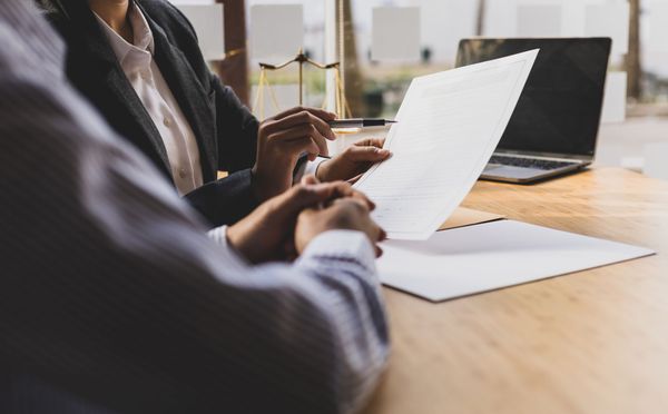 two people reviewing documents at a desk