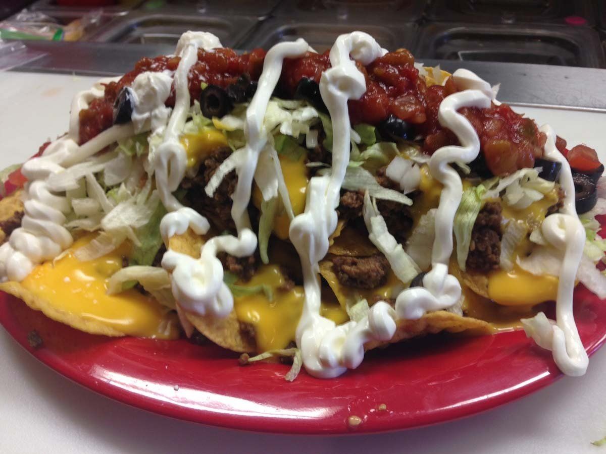 A close up of a plate of nachos on a table