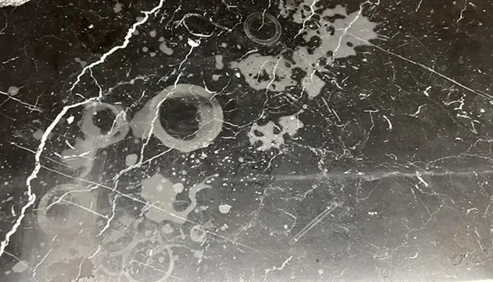 Etch marks on black marble