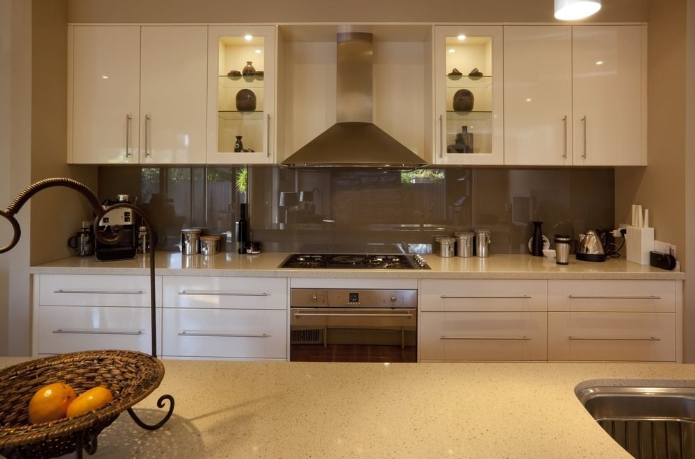 A kitchen with white cabinets and stainless steel appliances