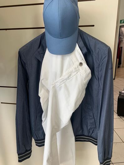 Cappotto blu navy, sciarpa, gilet e camicia a quadri disposti su una gruccia.