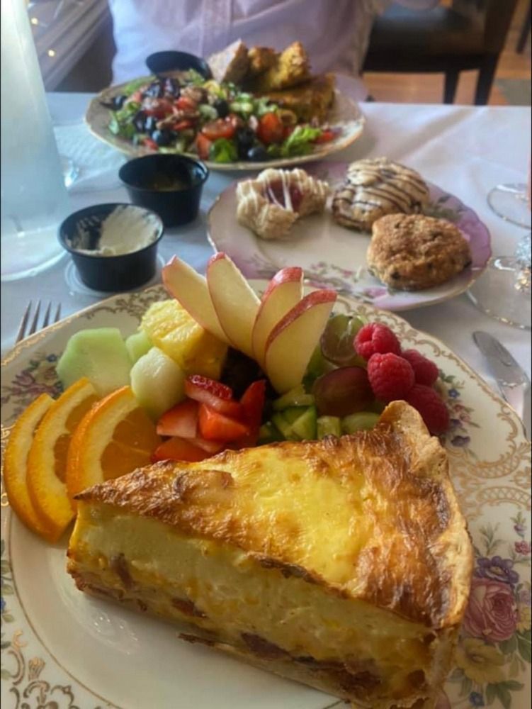 A plate of food with a slice of pie and fruit on it