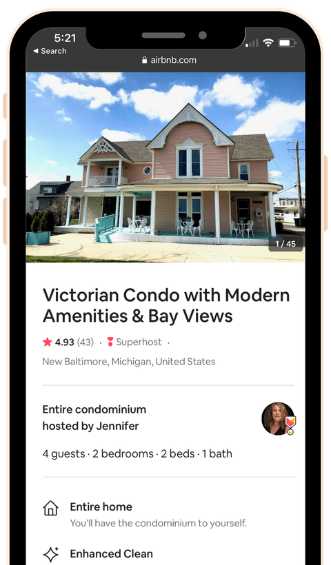 A phone screen shows a picture of a victorian condo with modern amenities and bay views.