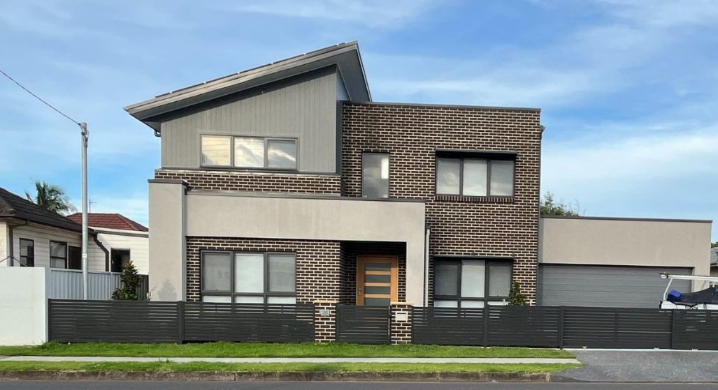 A Large House With a Car Parked in Front of It — Febos Welding and Engineering In Corrimal, NSW
