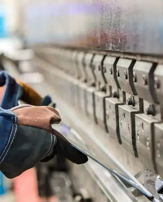 A Person is Working on a Machine in a Factory — Febos Welding and Engineering In Corrimal, NSW