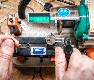 A person is cutting a key with a machine.