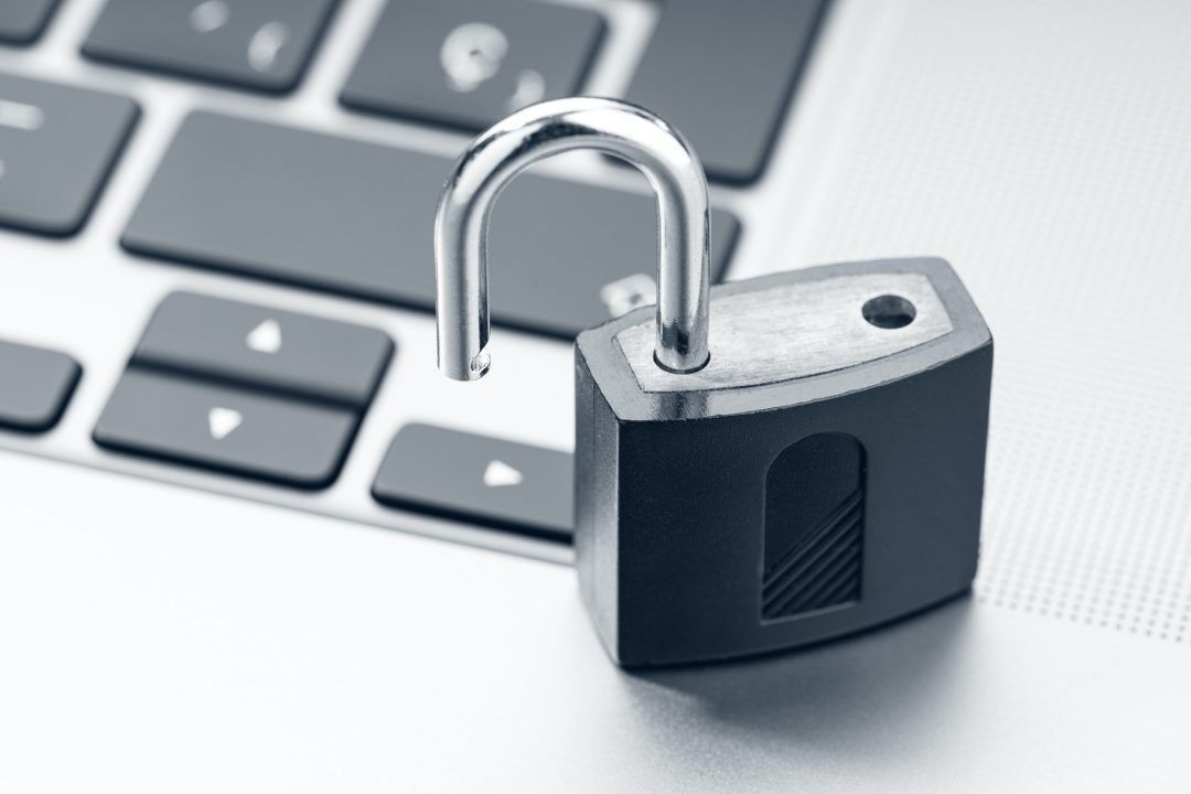 A padlock is sitting on top of a keyboard.