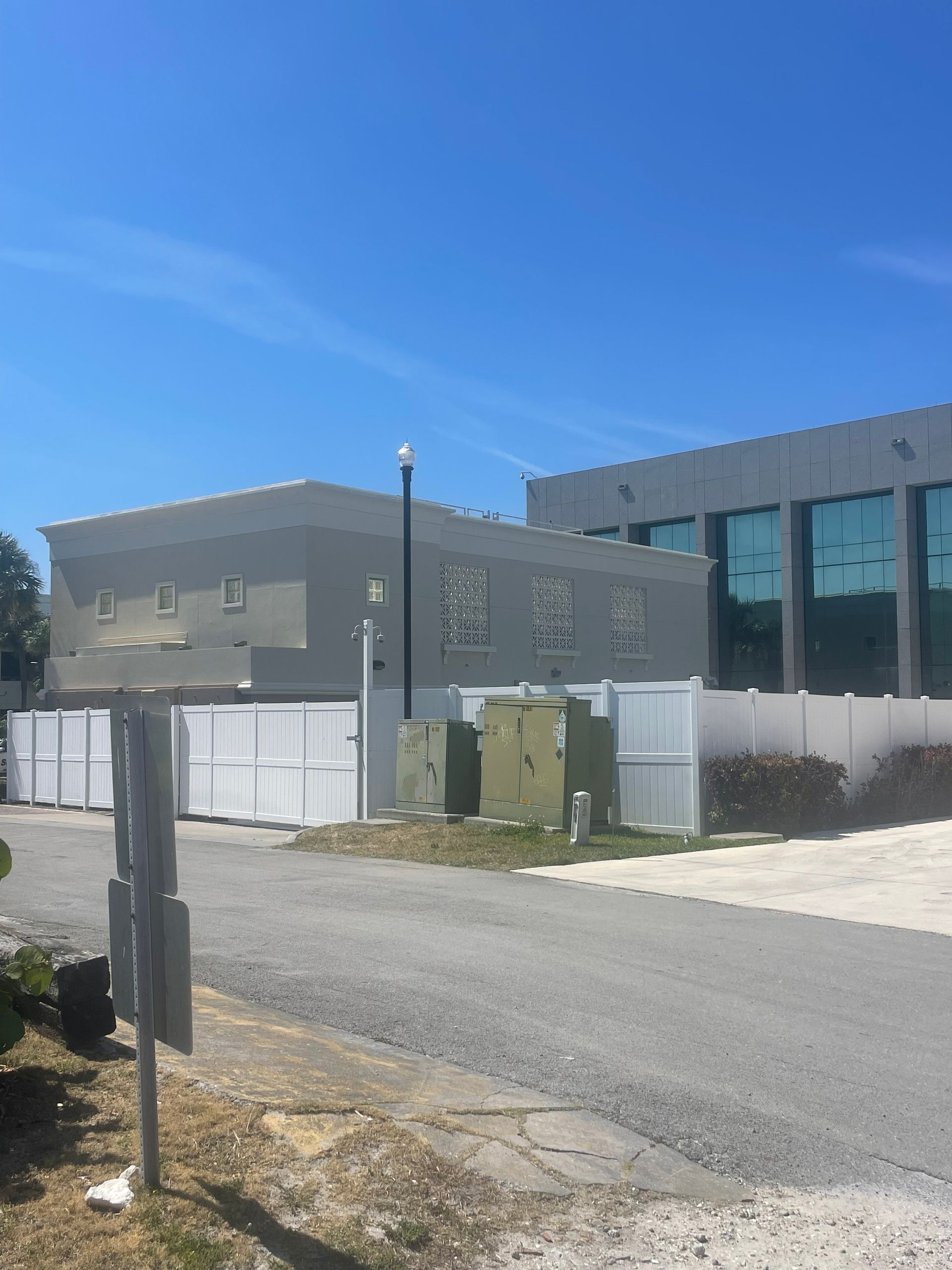 A large building with a white fence in front of it
