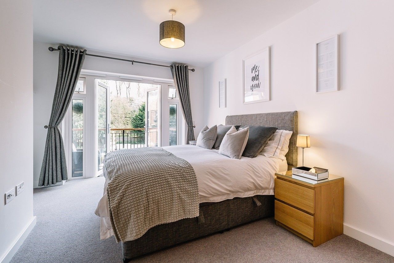 Large bed , bed room with sliding glass doors .