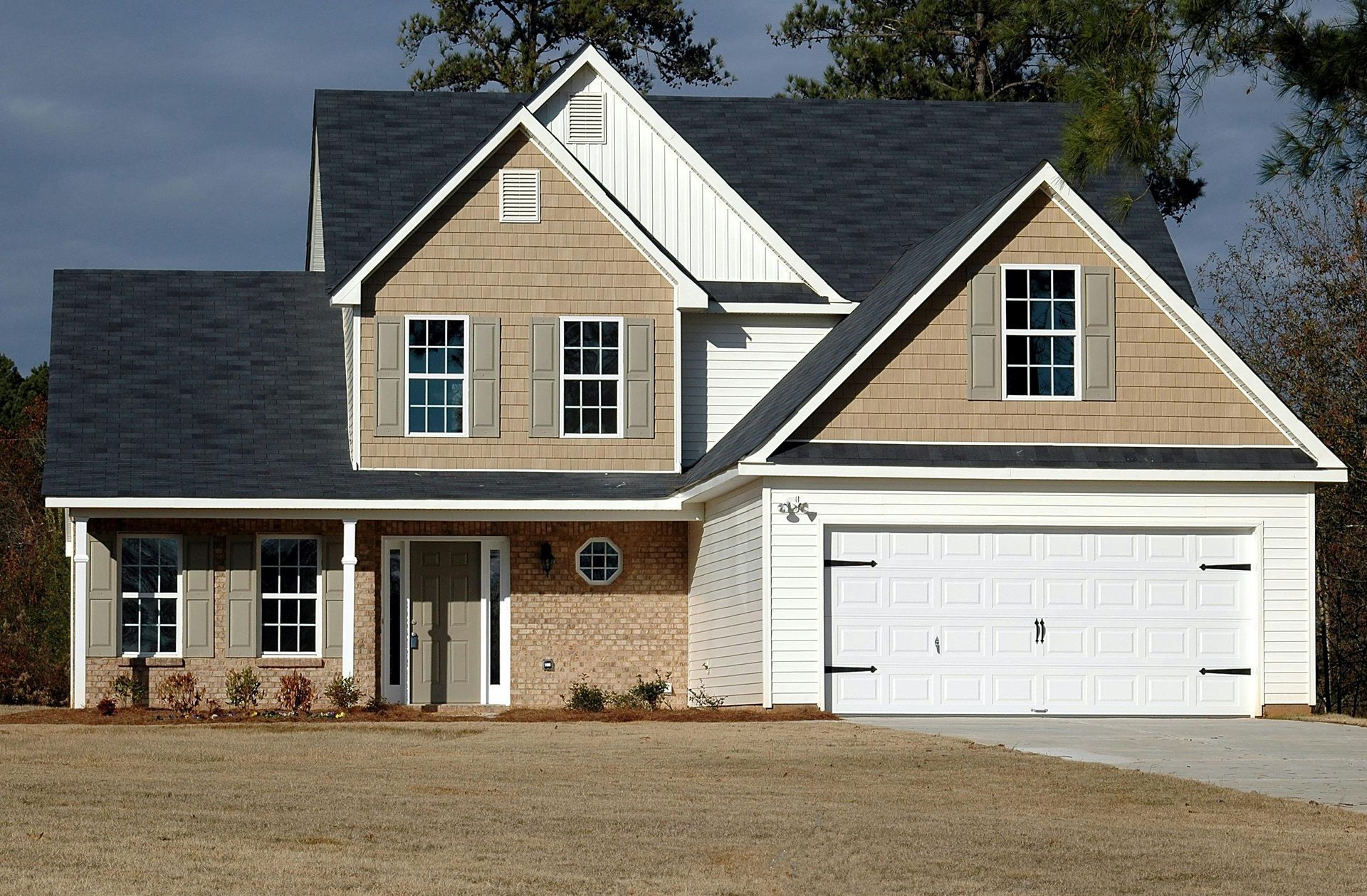A kitchen with white cabinets , granite counter tops , and stainless steel appliances.