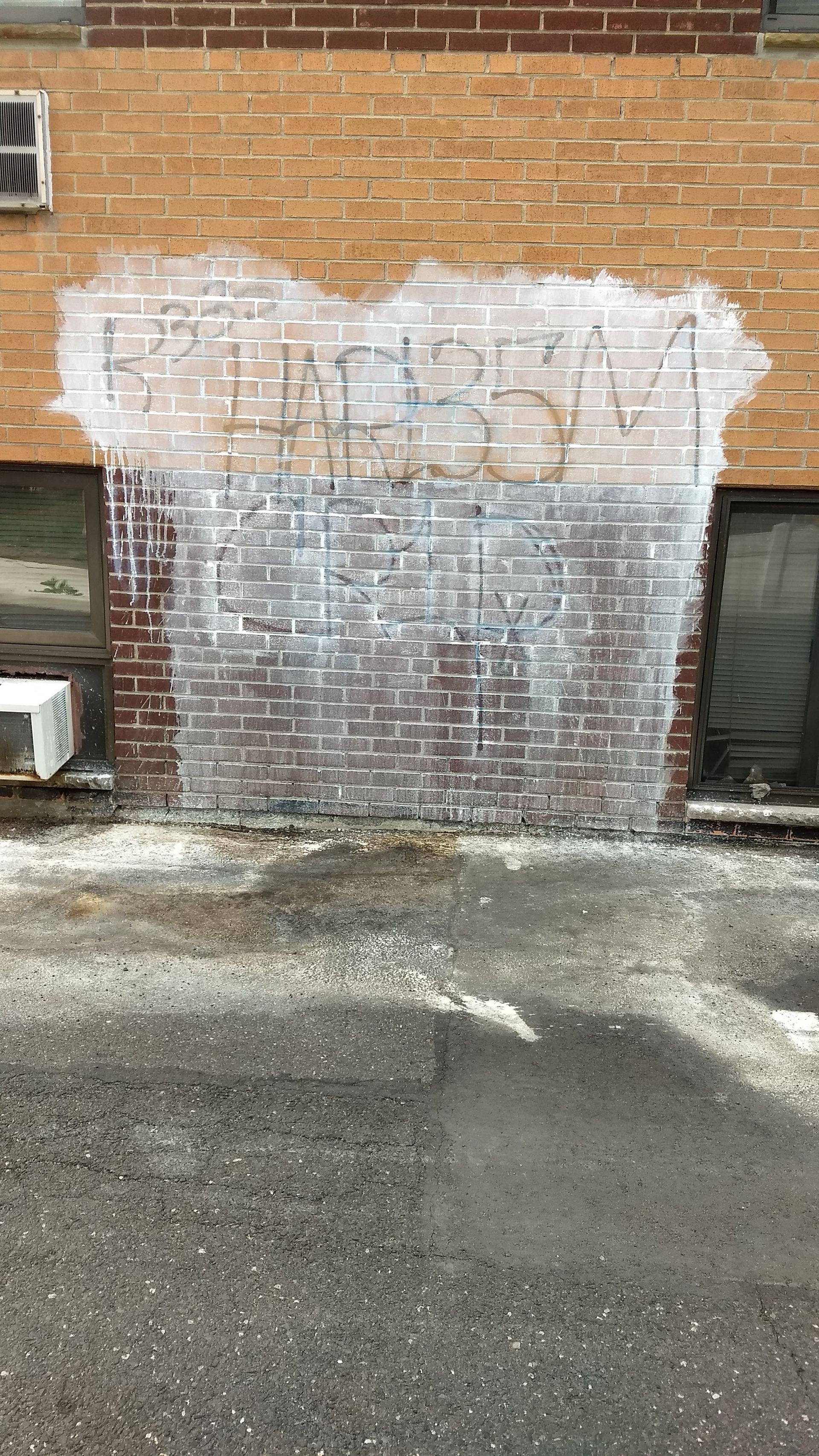 Before graffiti paint removal from brick in Philadelphia Pa.